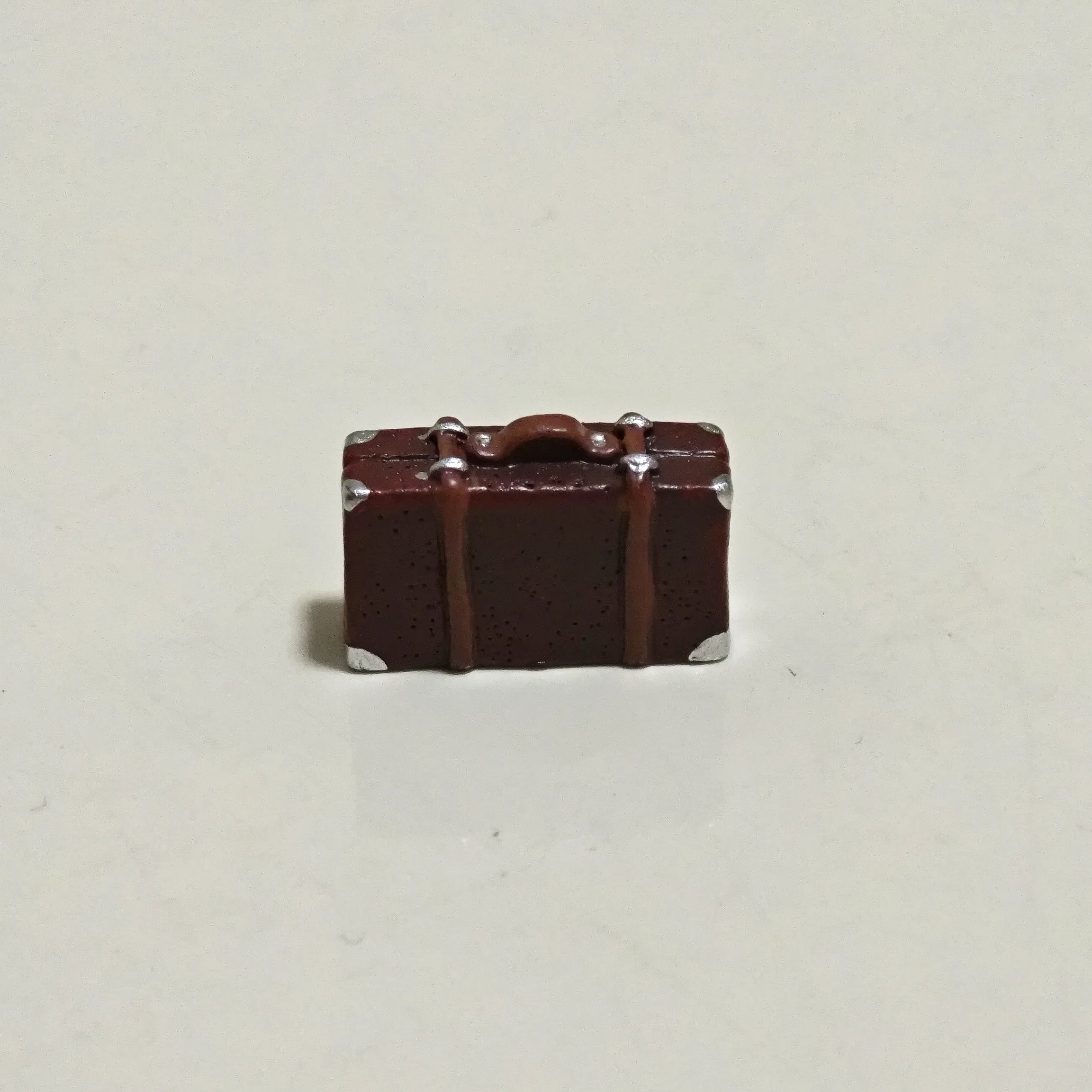 Detailed view of small vintage suitcase accessory for Hirono diorama display.
