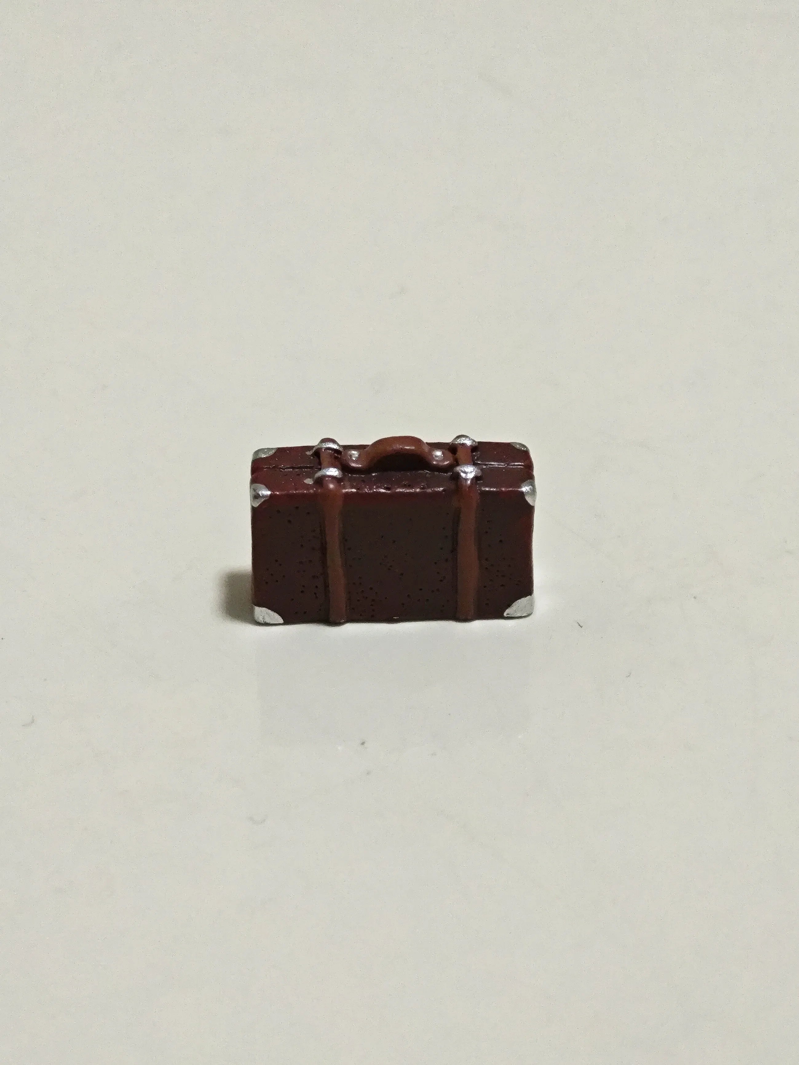 Detailed view of small vintage suitcase accessory for Hirono diorama display.