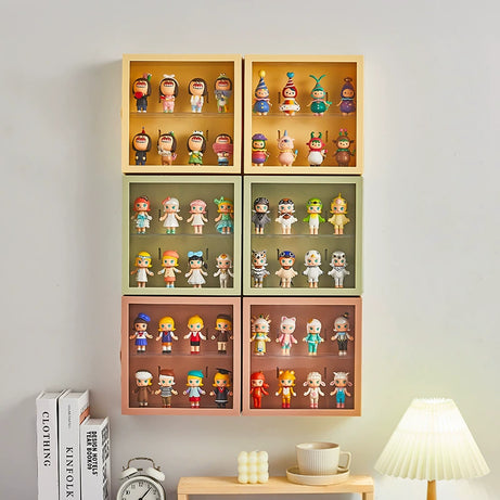 Six wall-mounted display shelves with three different colors and vinyl figurines inside. 
