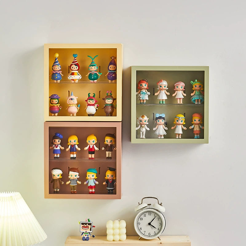 Three wall-mounted display shelves with three different colors and vinyl figurines inside.