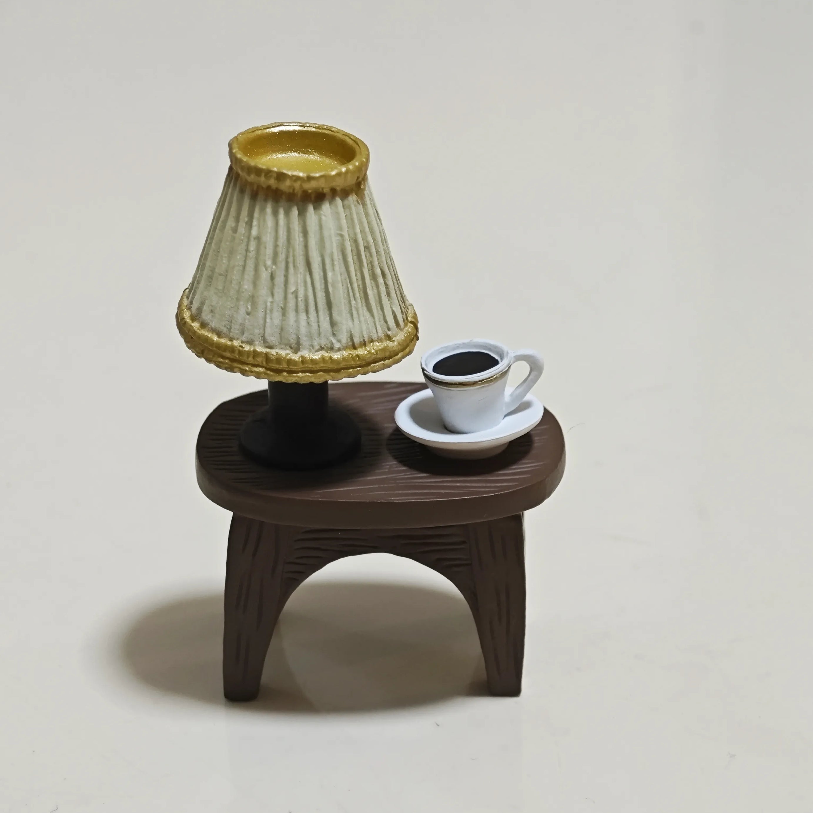Miniature wooden table featuring a lamp and coffee cup from Hirono Geographer diorama.