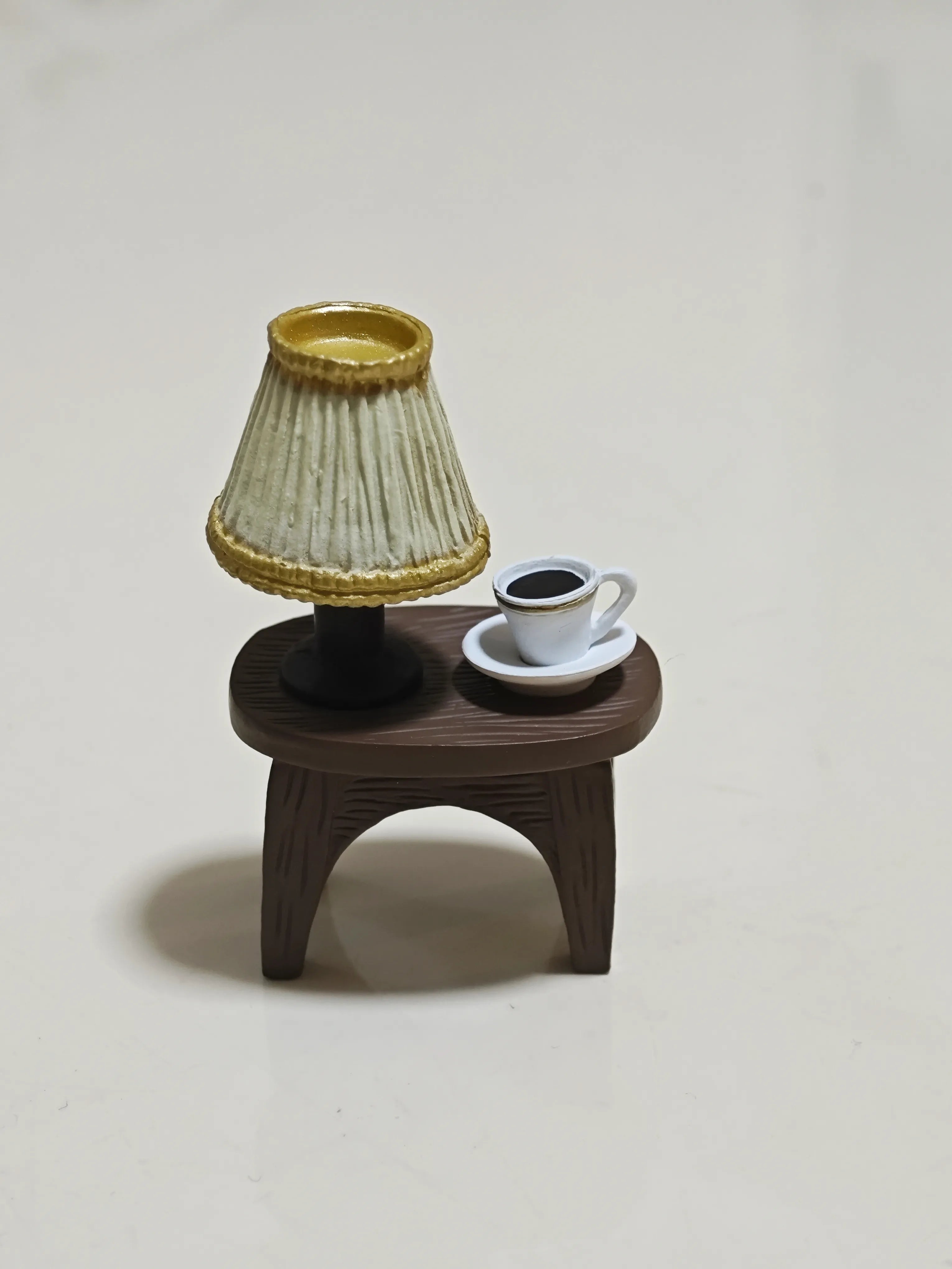 Miniature wooden table featuring a lamp and coffee cup from Hirono Geographer diorama.