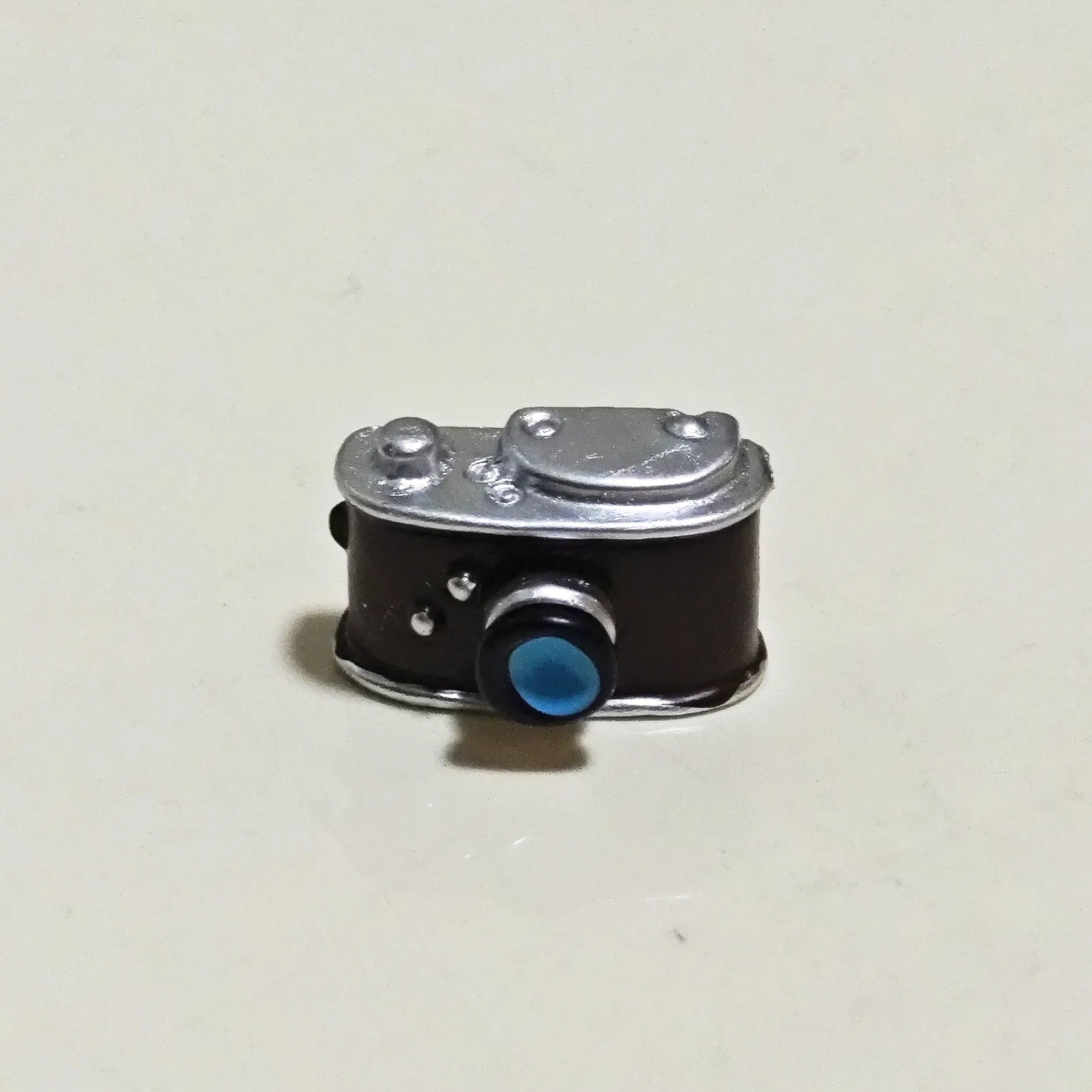 Detailed close-up of miniature vintage camera accessory included in Hirono's diorama set.