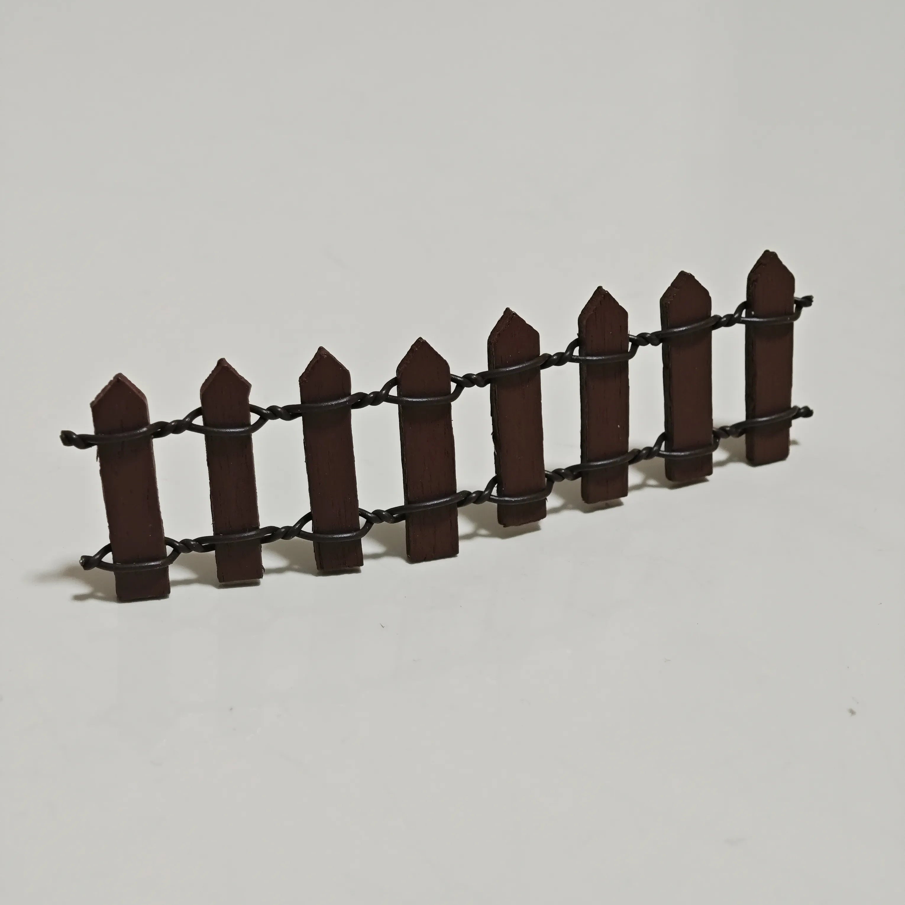 Close-up of miniature wooden fence accessory from Hirono diorama set.