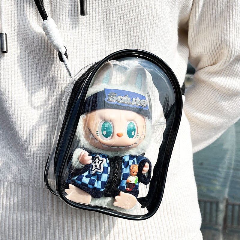 A transparent PVC display bag with a black strap, showcasing a Labubu figure in a blue checkerboard jacket. The bag is ideal for displaying Pop Mart figures while keeping them protected.