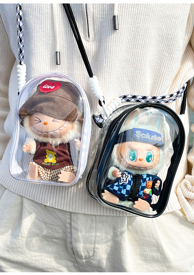 Two transparent PVC display bags featuring collectible Labubu figures. One bag has a white strap and a Labubu figure in a brown sweater, and the other has a black strap and a Labubu figure in a blue checkerboard jacket. Perfect for displaying and protecting Pop Mart collectibles.