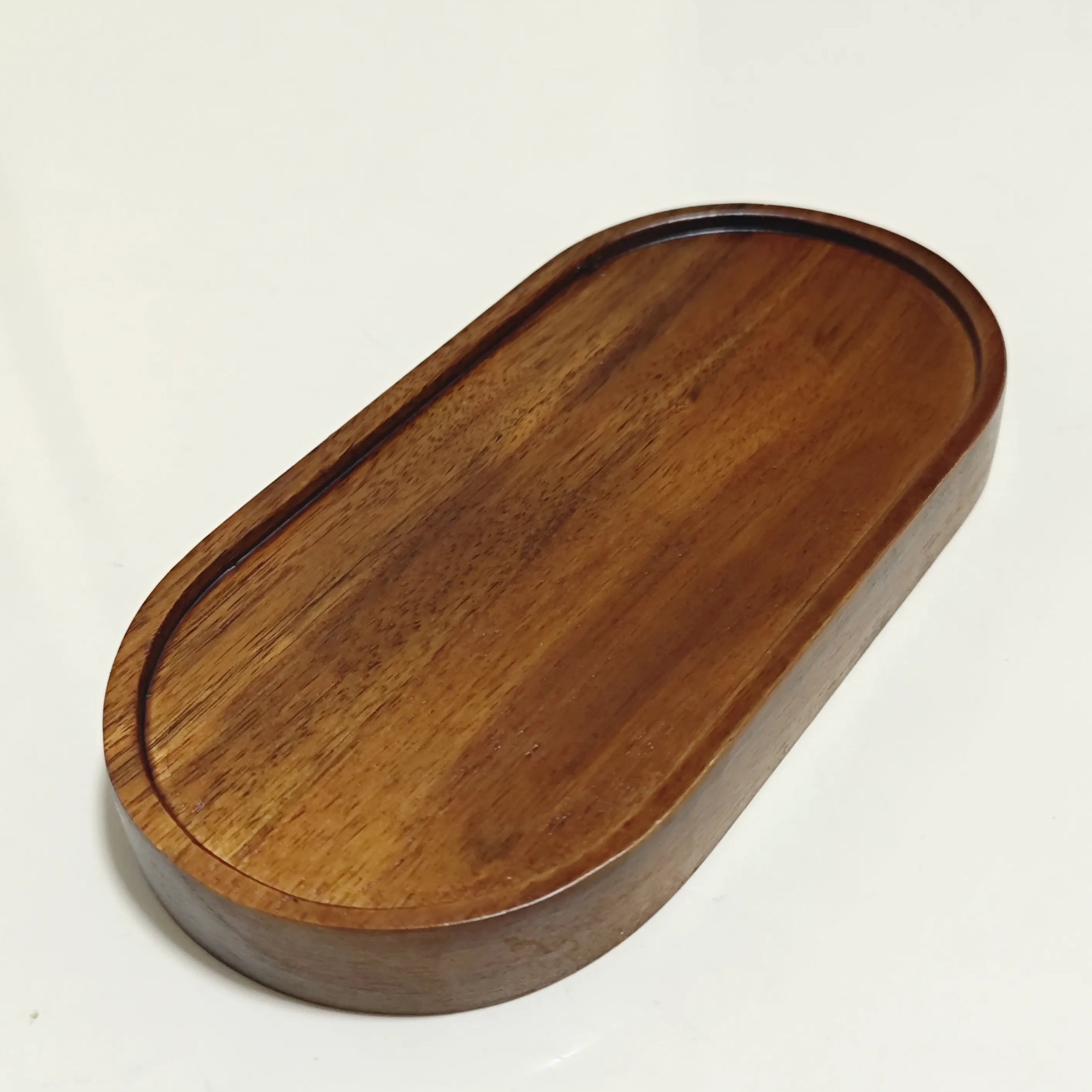 Empty polished wooden diorama base for displaying collectible figures and accessories.