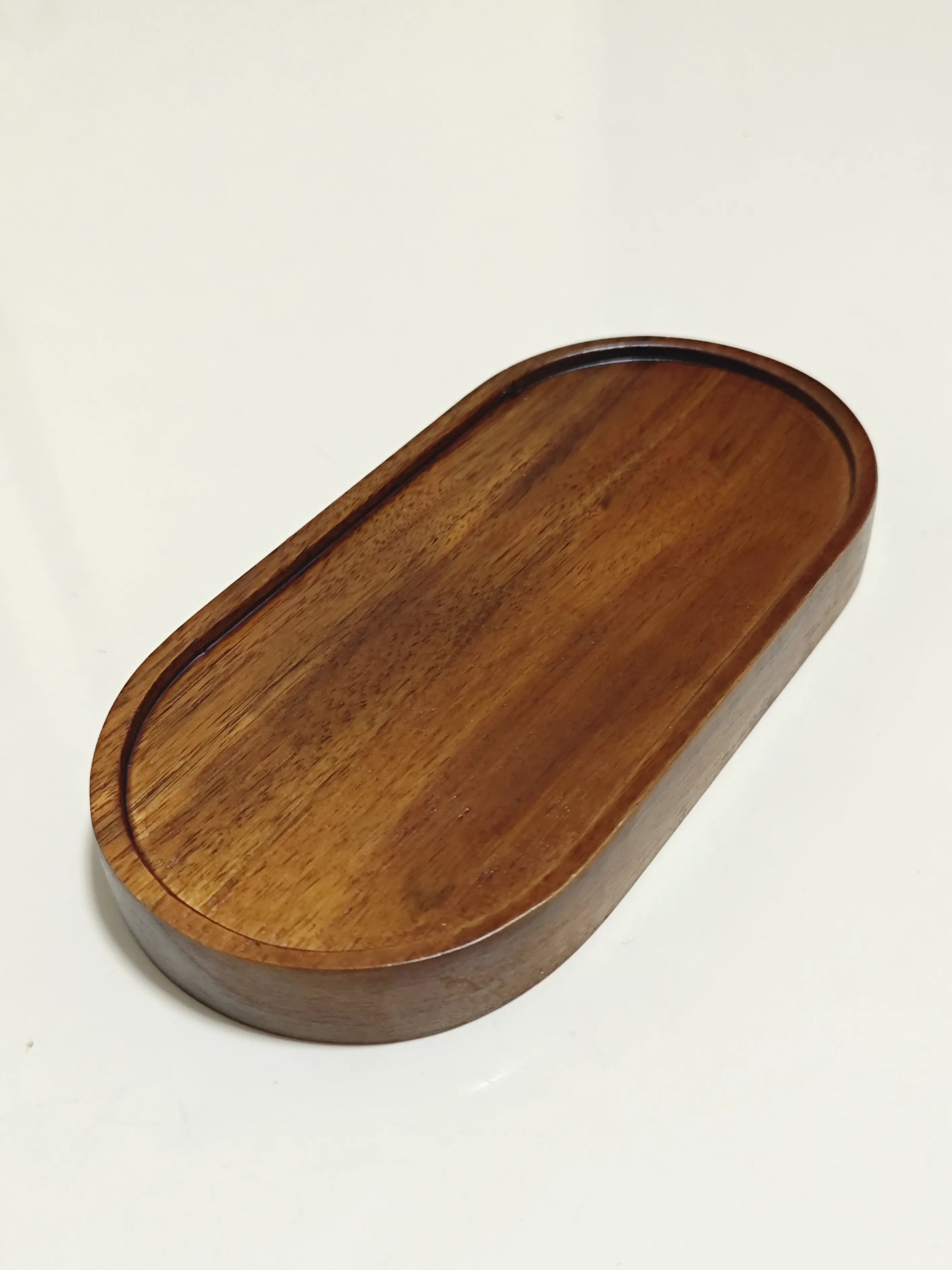 Empty polished wooden diorama base for displaying collectible figures and accessories.