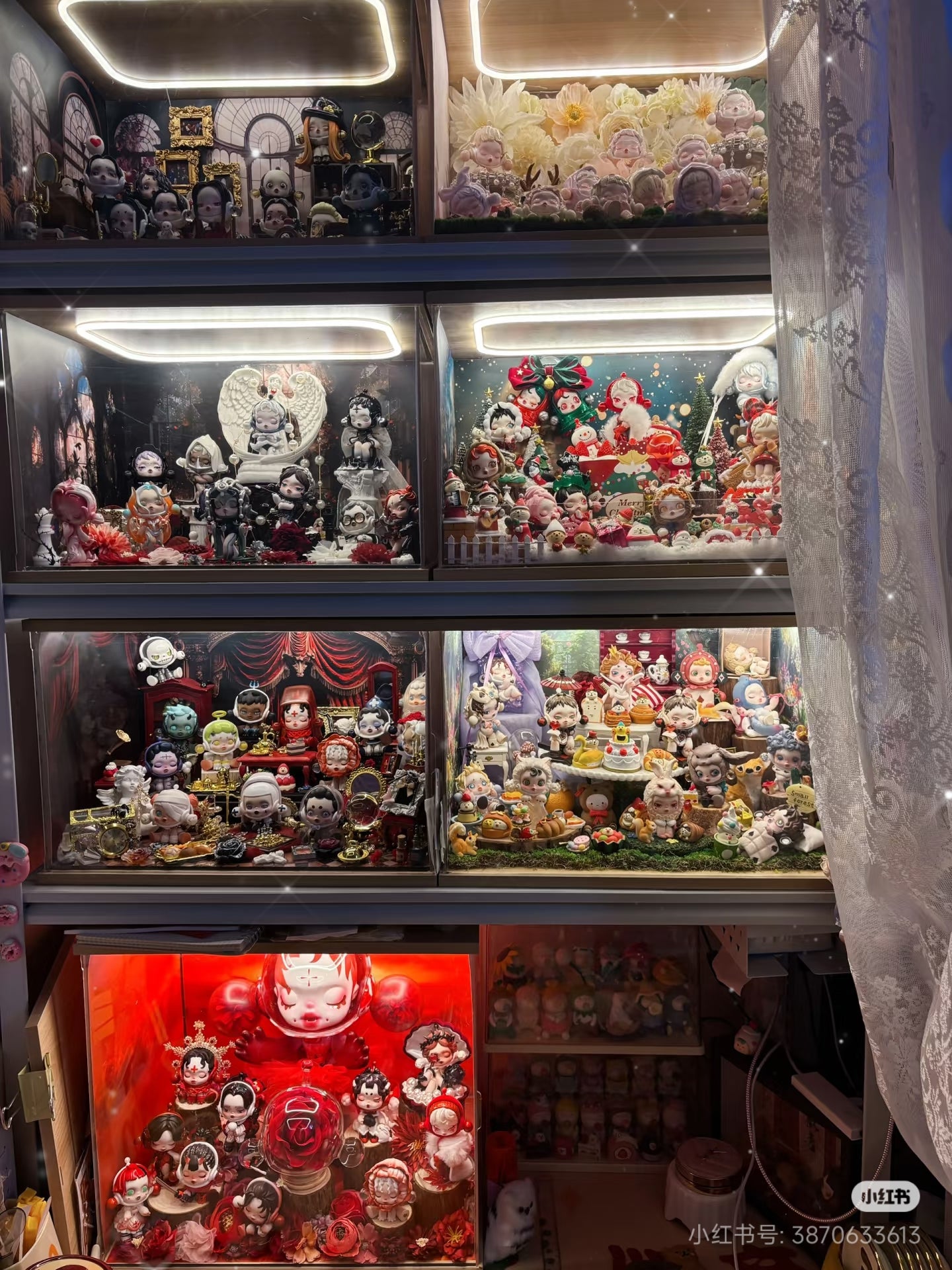 A dramatic, gothic-inspired collection of Skullpanda vinyl figures with ornate backdrops and built-in LED lighting inside a display case.