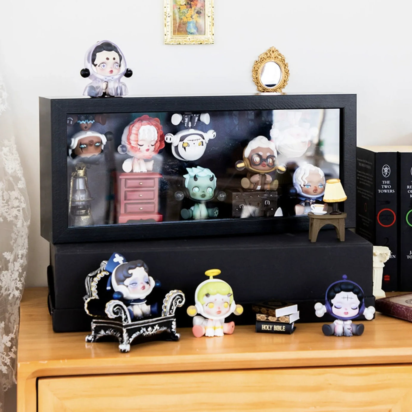 A medium-sized black wooden display case from Fig Palace with one layer, featuring a collection of designed Skullpanda figures from Popmart, each with distinct colors and styles,neatly arranged for display.