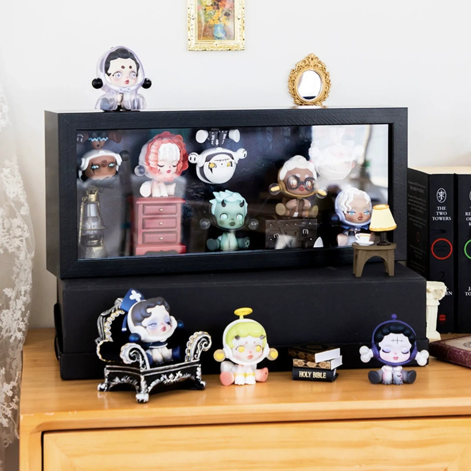A medium-sized black wooden display case from Fig Palace with one layer, featuring a collection of designed Skullpanda figures from Popmart, each with distinct colors and styles,neatly arranged for display.